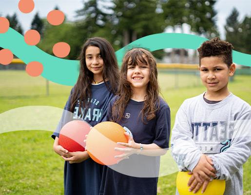 A group of kids wearing Seattle Kraken-branded clothing while holding brightly colored balls
